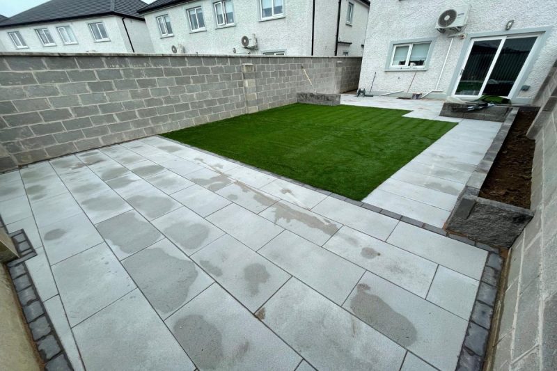 Patio with Newgrange Granite Flags Rockface Flowerbeds and Artificial Grass in Rathangan Co. Kildare
